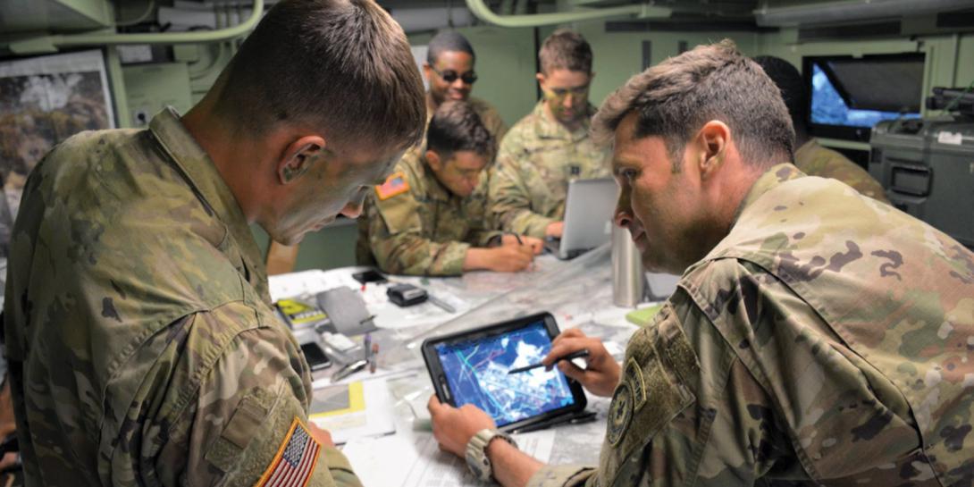 Maj. Matthew Bailey, USA, executive officer, 3rd Squadron, 2d Cavalry Regiment (3/2CR), and 1st Lt. Trevor Rubel, USA, battle captain for the tactical command post, 3/2CR, review an operational overlay on a Nett Warrior device in preparation for an airfield seizure during the NATO Saber Strike 18 exercise in Kazlu Ruda, Lithuania. U.S. Army photo by 1st Lt. Joshua Snell