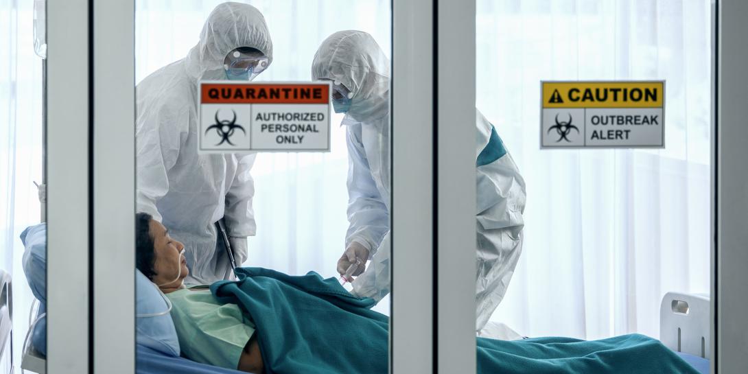 A COVID-19 patient is treated in a quarantine room by health care workers garbed in personal protective equipment. The pandemic has laid bare the shortcomings in U.S. national security emergency preparedness, and experts state that only a national effort will remedy the problem. Credit: Shutterstock/Mongkolchon Akesin