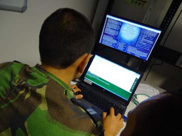 A Portuguese cyber defense operator peruses his laptop as he helps a security system protect against attacks. Portugal’s multinational cyber defense effort places a premium on education and training.
