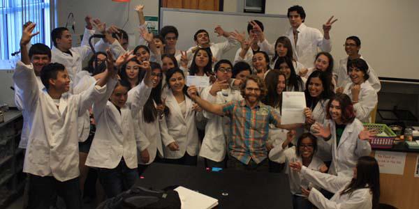 Surrounded by his students, Jeremy Jonas, chemistry and biology teacher at Tucson High Magnet School, receives his grant.