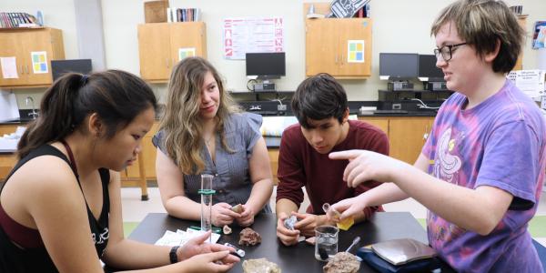 Boerne-Samuel V. Champion High School students (l-r) Gifford, Salas, Medina and Sara Owen conduct a lab on sedimentary rocks using new supplies purchased with a grant funded by the Alamo Chapter.