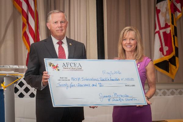 Lt. Gen. Robert M. Shea, USMC (Ret.), president and CEO of AFCEA International, accepts a check from Susan Lepera, former president of the Central Maryland Chapter, for the AFCEA Educational Foundation.