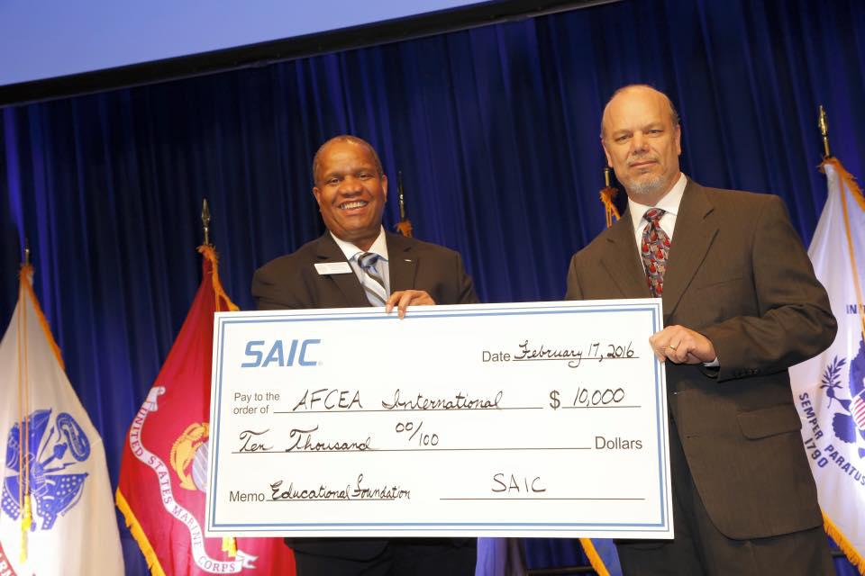 Michael Trovato (r) of SAIC presents a check to then-AFCEA Educational Foundation Executive Director Vince Patton.