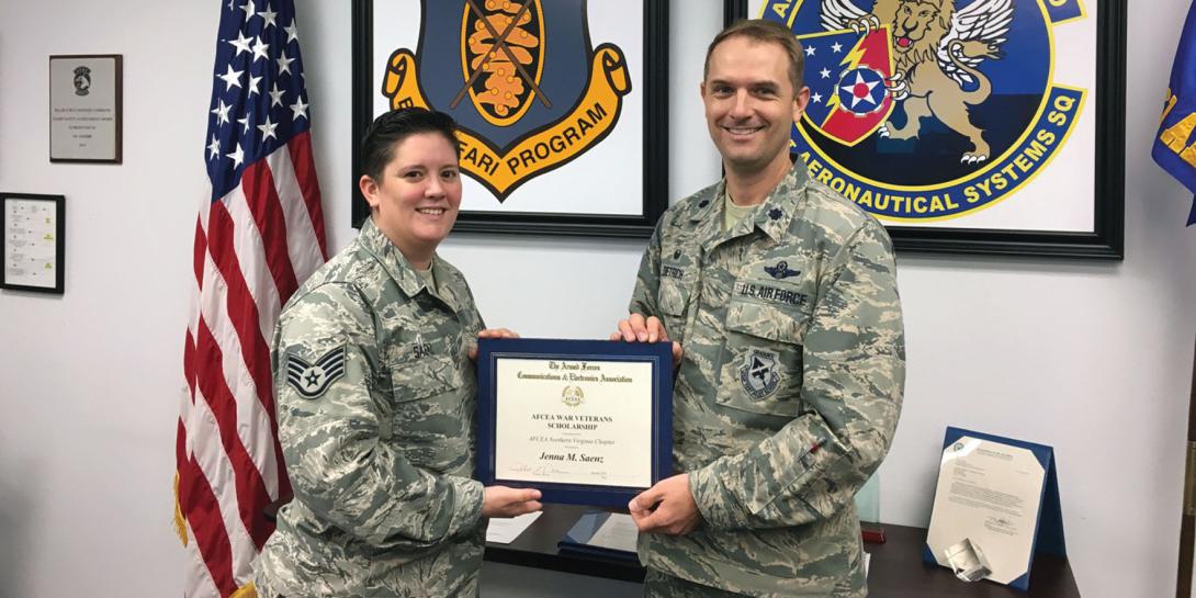 Staff Sgt. Jenna Saenz, USAF, American Military University (l), receives a 2017 War Veterans Scholarship from her commanding officer, Lt. Col. Jonathan Dietrich, USAF, 661st Aeronautical Systems Squadron.