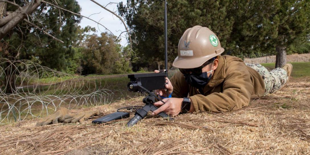 A member of the Naval Mobile Construction Battalion 5 sets up automated surveillance cameras that use artificial intelligence (AI). As AI matures, its uses will extend into individual collection hardware. U.S. Navy photo
