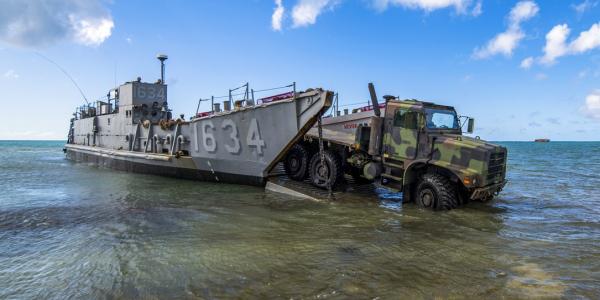 A U.S. Army light medium tactical vehicle departs for the beachfront from a U.S. Naval Landing Craft Utility operating out of the USS Ashland (LSD 48) providing typhoon relief on Saipan, Commonwealth of the Northern Mariana Islands in November 2018. With military activity worldwide, the Army Contracting Command has to meet global demands.  U.S. Air Force photo by Tech. Sgt. Christopher Ruano