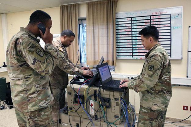 Three U.S. Army soldiers manage company network operations at Hohenfels Training Area in Germany. A key requirement for future Army networking is that command posts be mobile, agile and integratable. Army photography by William B. King