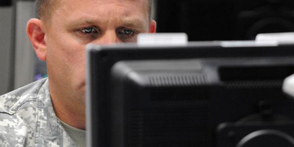 A serviceman monitors his computer during the Cyber Guard 2015 exercise. Efforts within the Defense Information Systems Agency (DISA) may lead to defense personnel receiving a cybersecurity lesson every time they log on to a military network.