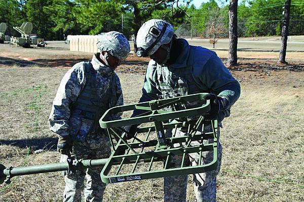 Two signal soldiers set up an antenna at a training site in Fort Gordon, Georgia. Keeping signaleers up-to-date is a primary challenge, as the development of new technologies is outpacing the ability to train.