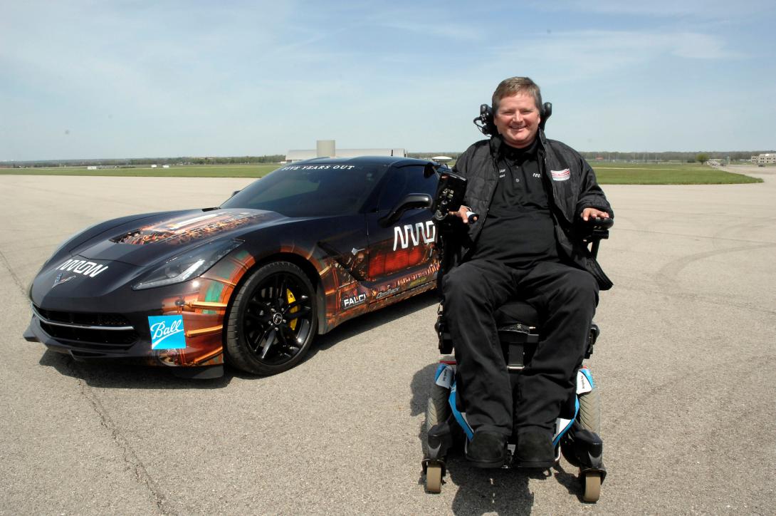 Sam Schmidt, former IndyCar driver, is stationed in front of a semiautonomous Corvette. One Air Force Research Laboratory team helped develop the interface that allowed Schmidt to control the car using head movements. Another team used sensors to monitor his performance during the man-and-machine collaboration project.