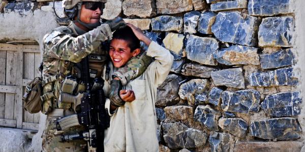 A U.S. Army soldier gives a playful head rub to a to a local boy while on patrol near Forward Operating Base Salerno in Afghanistan. Human intuition may one day help artificial intelligence distinguish between safe and dangerous scenarios.