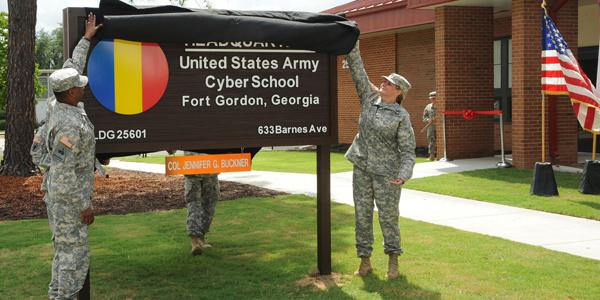 Maj. Gen. LaWarren Patterson, USA, the U.S. Army Cyber Center of Excellence and Fort Gordon commander, and Col. Jennifer Buckner, USA, Army Cyber School commandant, unveil a sign during a ribbon-cutting ceremony for the school.
