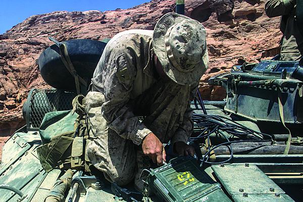 Lance Cpl. Tanner Ornduff, USMC, radio operator, sets up a AN/PRC-117F radio on an amphibious assault vehicle during a training event in Al Quweira, Jordan last year. The MCTSSA radio frequency laboratory began evaluating software-defined radios before they were widely deployed.