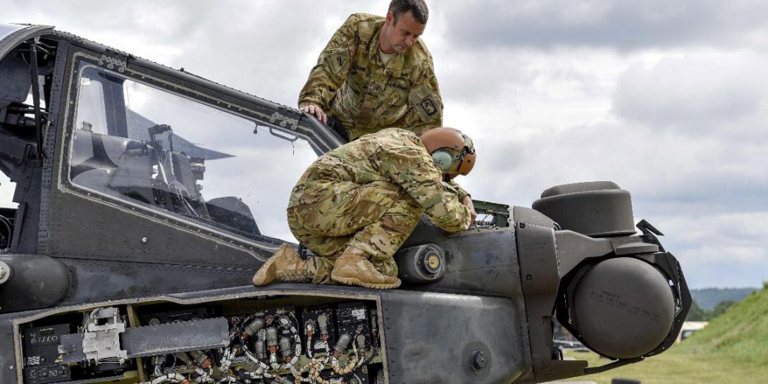 Soldiers conduct preventive maintenance checks on an AH-64D Apache Longbow helicopter during training at the Grafenwoehr Training Area in Germany. Army photo by Spc. Nathanael Mercado