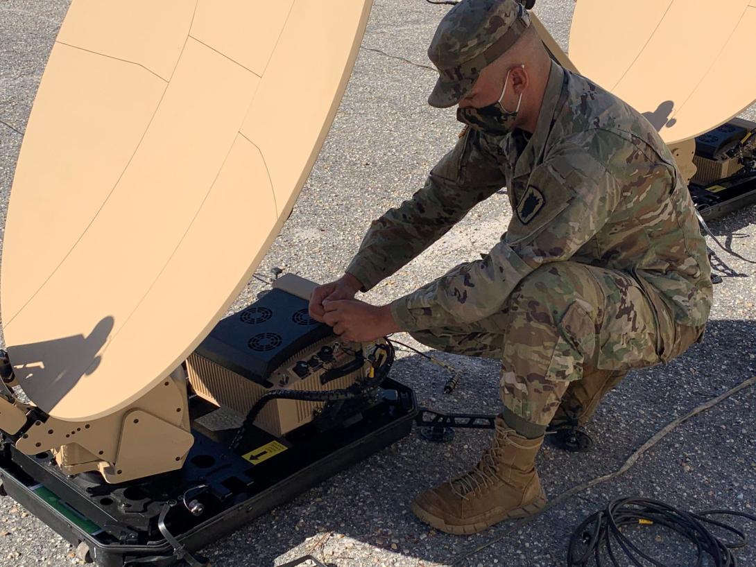 A Scalable Network Node operator with the 50th Expeditionary Signal Battalion-Enhanced connects cables to the Very Small Aperture Terminal modem during new equipment training at Fort Bragg, North Carolina. The new nodes are among the modernization equipment changing the way enhanced signal battalions will operate in the future.   U.S. Army photo