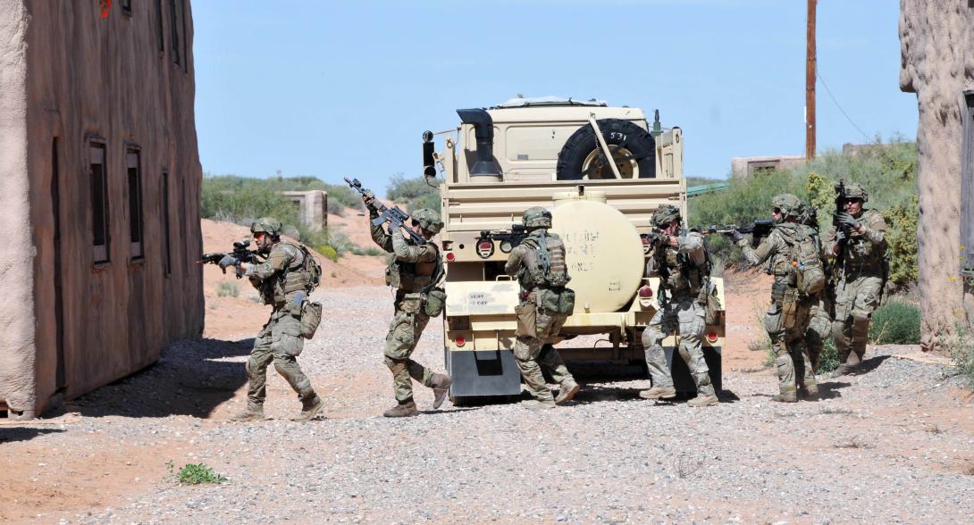 Soldiers with the Royal Danish Army seek cover in a building during a 2015 Bold Quest mission in the training village of Kamal Jabour, Fort Bliss, Texas. Bold Quest is a multinational mission linking international armies for training with the intent of testing communication capabilities. The Defense Department uses Bold Quest to assess JADC2 capabilities and mission partner interoperability. Credit: Spc. Aura E. Sklenicka, 2/1 ABCT, PAO