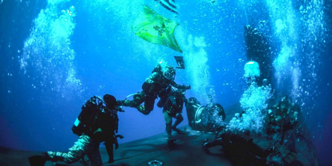 Navy SEALs conduct diving operations with the attack submarine USS New Mexico during training in the Mediterranean Sea in June 2021. The Undersea Warfighting Development Center helps integrate a variety of technologies and capabilities for the undersea warfare mission. Photo courtesy of U.S. Navy