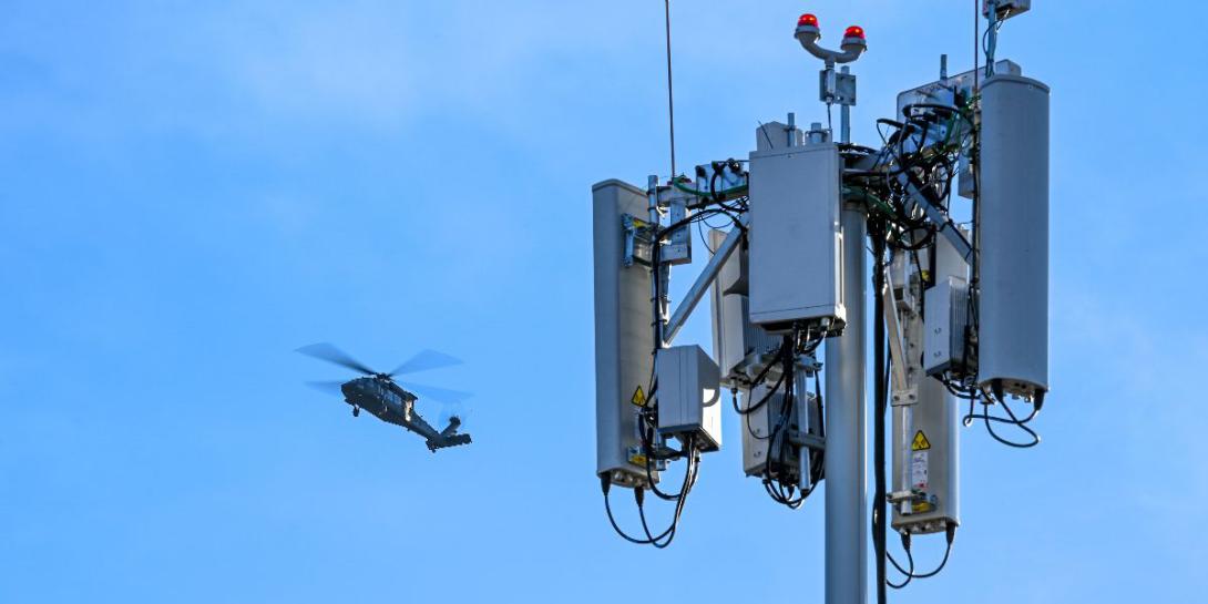 An UH-60 Blackhawk flies multiple passes at different altitudes over the runway during a series of 5G avionics tests March 2, 2022, at Hill Air Force Base, Utah. A 5G mobile test station was used during the testing as part of demonstration to implement 5G technologies without compromising the safety of military and civilian aircraft. U.S. Air Force photo by Cynthia Griggs