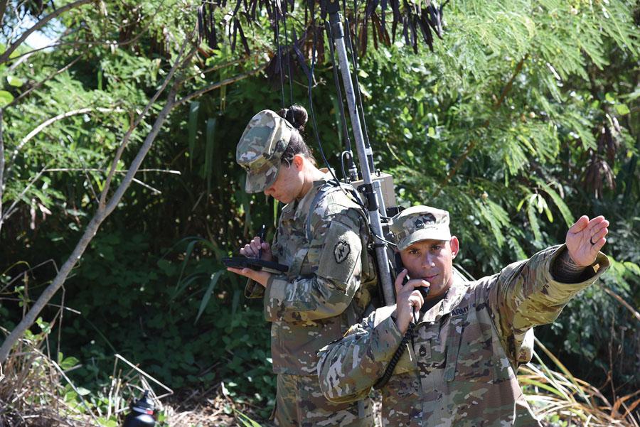 Two electronic warfare soldiers from the 2nd Infantry Brigade Combat Team conduct pre-combat checks and inspections to ensure that their equipment is working properly. U.S. Army photo by 1st Lt. Jordan Linder, USA