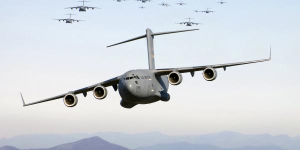 Thirteen C-17 Globemaster III aircraft fly over the Blue Ridge Mountains in Virginia during low-level tactical training. U.S. Transportation Command, which mobilizes troops and equipment around the world, is moving its cyber and command and control systems to a commercial cloud environment.  U.S. Air Force photo by Staff Sgt. Jacob N. Bailey, USAF