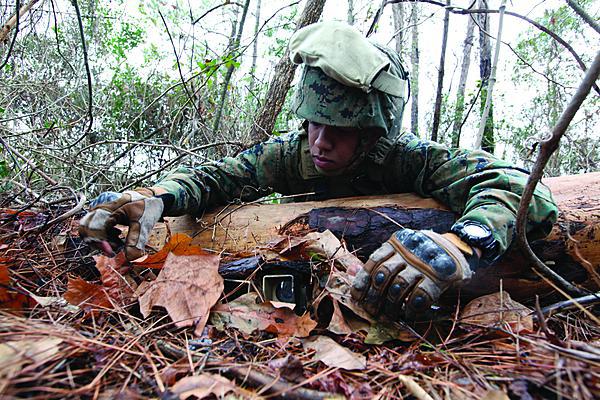 U.S. Marine Corps Lance Cpl. Ariel Tolentino, a sensor surveillance operator, conceals two cameras on the ground during an operational check at Camp Lejeune, N.C. The U.S. Army Research Laboratory is developing isotope-powered batteries that could allow unattended ground sensors to continue operating for far greater periods that today’s chemical batteries will allow.