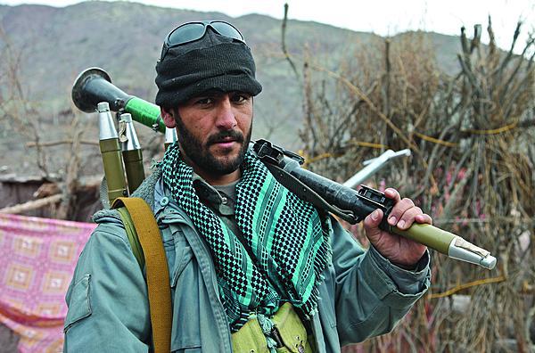 An Afghan Uniform Police officer provides security with a rocket-propelled grenade launcher while U.S. Army medics attend to patients at the Azrah district clinic in Logar province, Afghanistan. Artificial intelligence may one day identify rocket propelled grenades and other weapon systems.