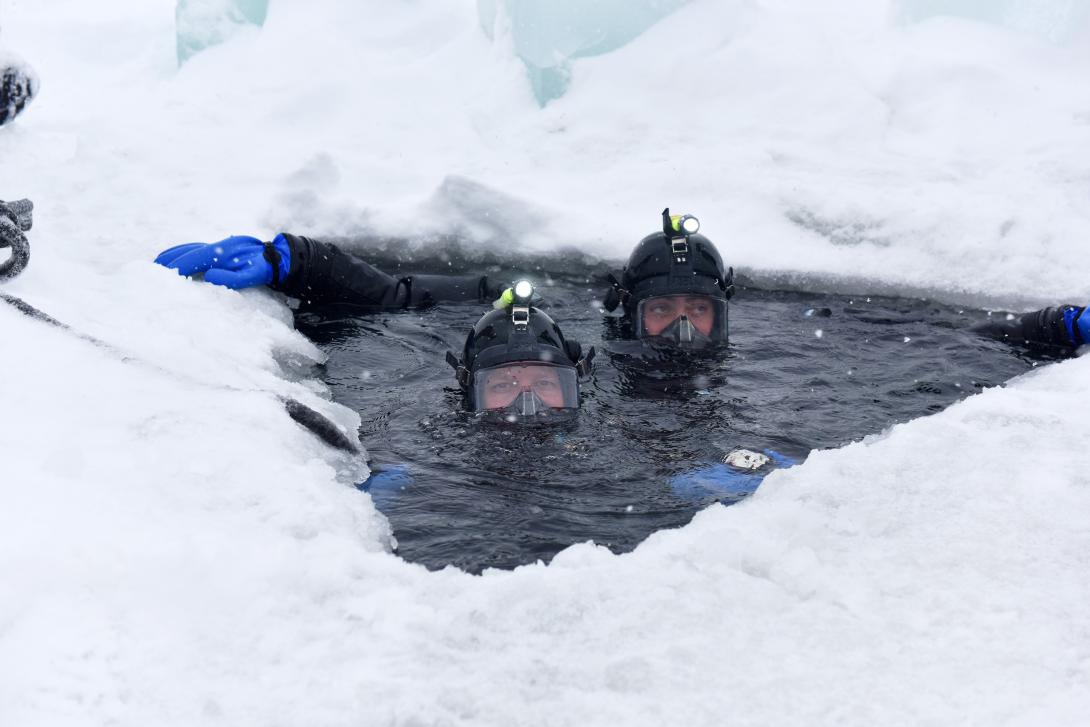 Navy divers participate in under-ice training at Camp Ripley, Minnesota, on February 8. A variety of factors, including melting Arctic ice caps, could require a greater focus on maritime operations. Photo by Navy Staff Sgt. Anthony Housey