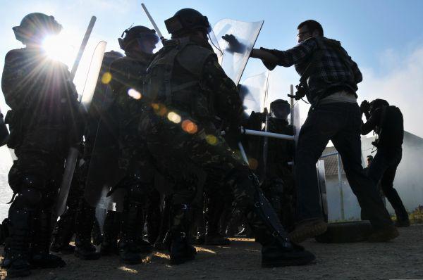 Albanian soldiers are attacked in a simulated riot during training at the Joint Multinational Readiness Center in Hohenfels, Germany. Researchers working with the Intelligence Advanced Research Projects Agency use open source intelligence to predict social upheaval events.