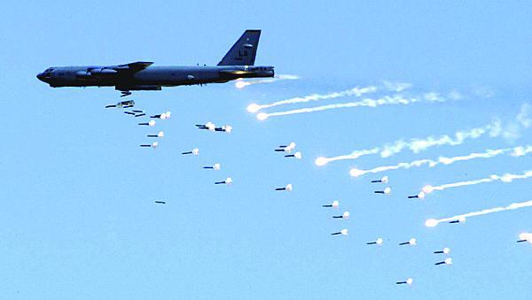 A B-52 Stratofortress from Barksdale Air Force Base, Louisiana, drops live ordnance over the Nevada Test and Training Range during an Air Force firepower demonstration. An array of aircraft, including B-52s, unmanned vehicles, tankers and command and control aircraft, are destined to receive cutting-edge cryptographic systems designed by the U.S. Naval Research Laboratory.