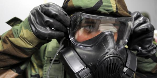 A senior airman removes his gas mask during a readiness drill. Because traditional biometric authentication techniques such as fingerprints and facial scans are not always practical for warfighters, Defense Information Systems Agency (DISA) officials are developing a prototypical system to track gait patterns and frequently visited locations.
