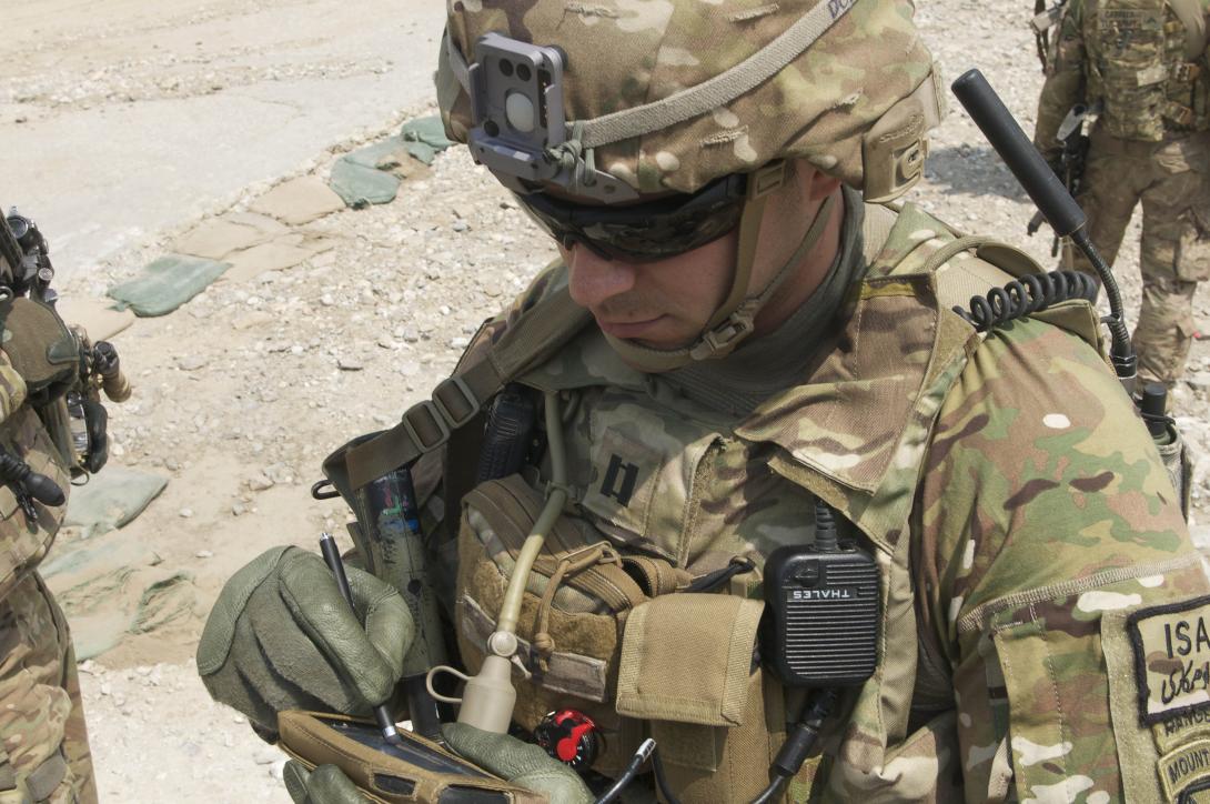 Capt. Jonathan Page, USA, uses the Rifleman Radio and Nett Warrior end-user device of the Army’s Network Capability Set 13 at Nangalam Base, Afghanistan. The Army awarded contracts to Harris Corporation and Thales Defense and Security Incorporated in April for the Rifleman Radio.