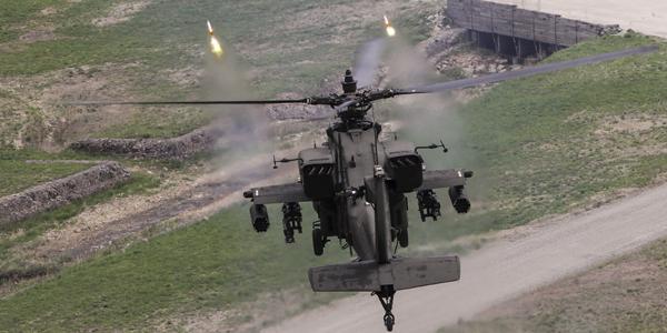 A U.S. Army AH-64 Apache fires point detonation rounds during a training exercise in South Korea. The Army intends to equip its helicopter fleet with the Small Airborne Networking Radio.