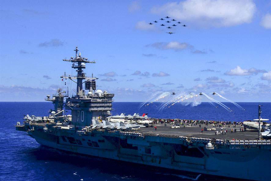 U.S. Navy aircraft fly in formation during an airpower demonstration above aircraft carrier USS Carl Vinson in the Pacific Ocean. The United States and India have formed a cooperative working group on aircraft carrier design and construction.