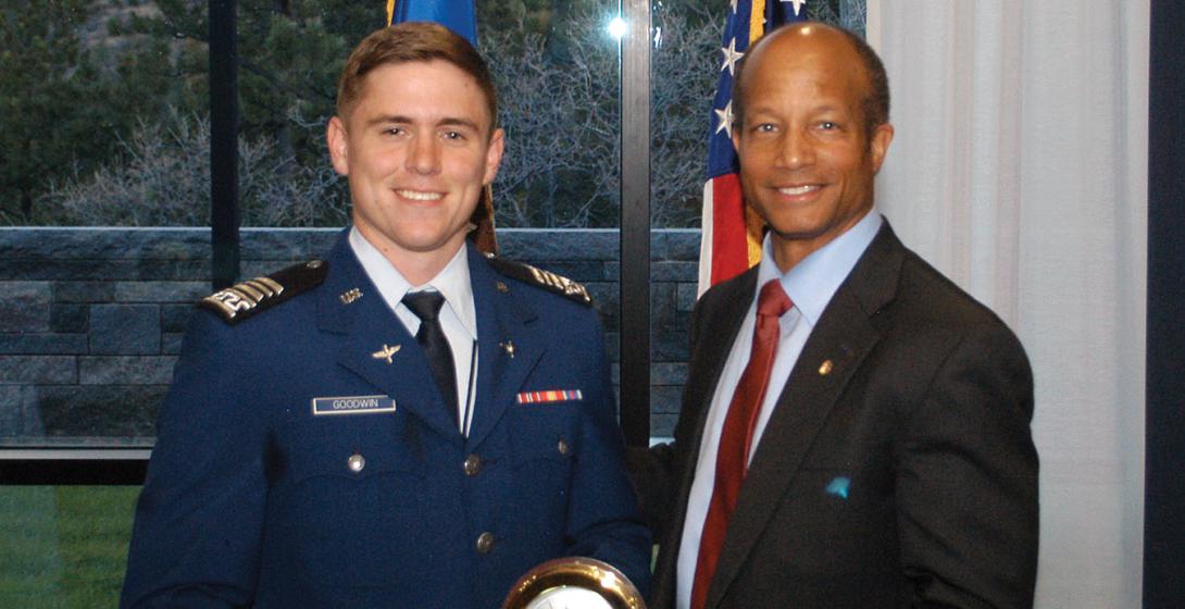 Cadet Jacob Goodwin (l), U.S. Air Force Academy, receives the Lt. Gen. Gordon T. Gould Jr., USAF, Honor Award from Col. Robert Wright, USAF (Ret.). This commissioning award at the Air Force Academy was named after Gen. Gould in 1983. He was an electronics engineer who graduated from the U.S. Military Academy in 1941 and was instrumental in enhancing the communications career field, giving it the recognition it deserved.