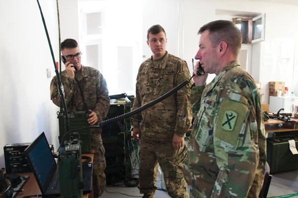 Staff Sgt. Nelson confirms that Spc. John Williams, USA, and Spc. Jeffery Evans, USA, configured the communication programming application correctly. Spc. Williams and Spc. Evans are assigned to Company B, 151st Expeditionary Signal Battalion during a high frequency radio class. Credit: 1st Class Kimberly D. Calkins, ANG