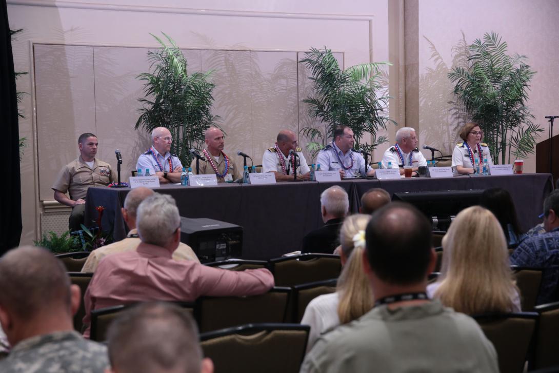 Comprising the J-6 panel are (l-r) Lt. Col. Leonard J. LeVine, USMC, MARFORPAC; Col. Kevin M. Payne, USAF, U.S. Forces Korea; Col. Jay Matos III, USMC, DISA Pacific; Capt. William A. Dodge, USN, NCTAMSPAC; Col. Michael Finn II, USAF, U.S. Pacific Air Forces; Maj. Gen. Wayne Brock III, USAR, U.S. Army Pacific; and moderator Rear Adm. Kathleen M. Creighton, USN, PACOM.