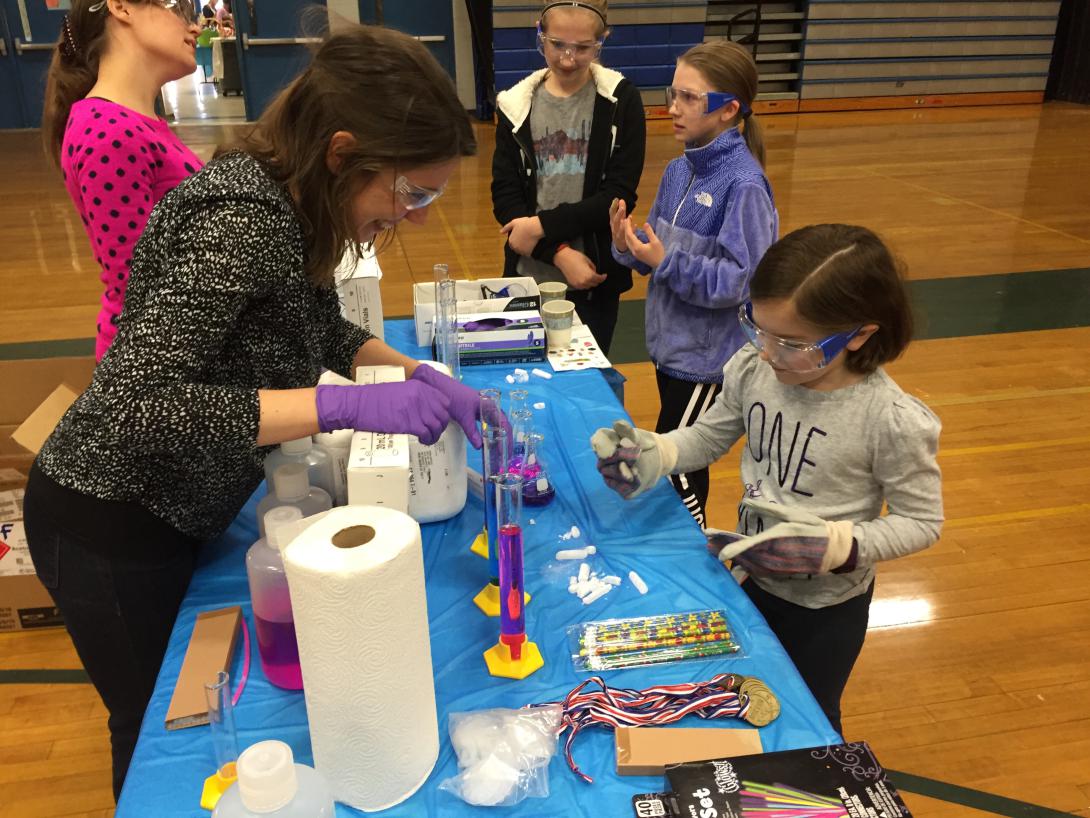 Graduates from Yale engage young students in chemistry experiments at last year's Make-Her Fair.