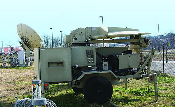 Tactical communications equipment line the field outside the facility housing the U.S. Army Communications-Electronics Command (CECOM) Joint On-demand Interoperability Network, or JOIN. This equipment allows JOIN to network diverse types of users in their own environment for massive joint testing and evaluation.