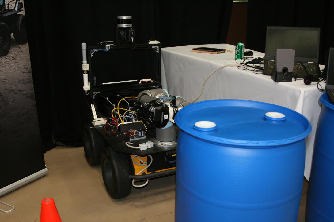 If faced with two potentially dangerous barrels apart in a roadway, this robot will use its sensors and its mechanical arm to determine which one is only partly full. That barrel then will be moved out of the way to clear a safe path for soldiers. 