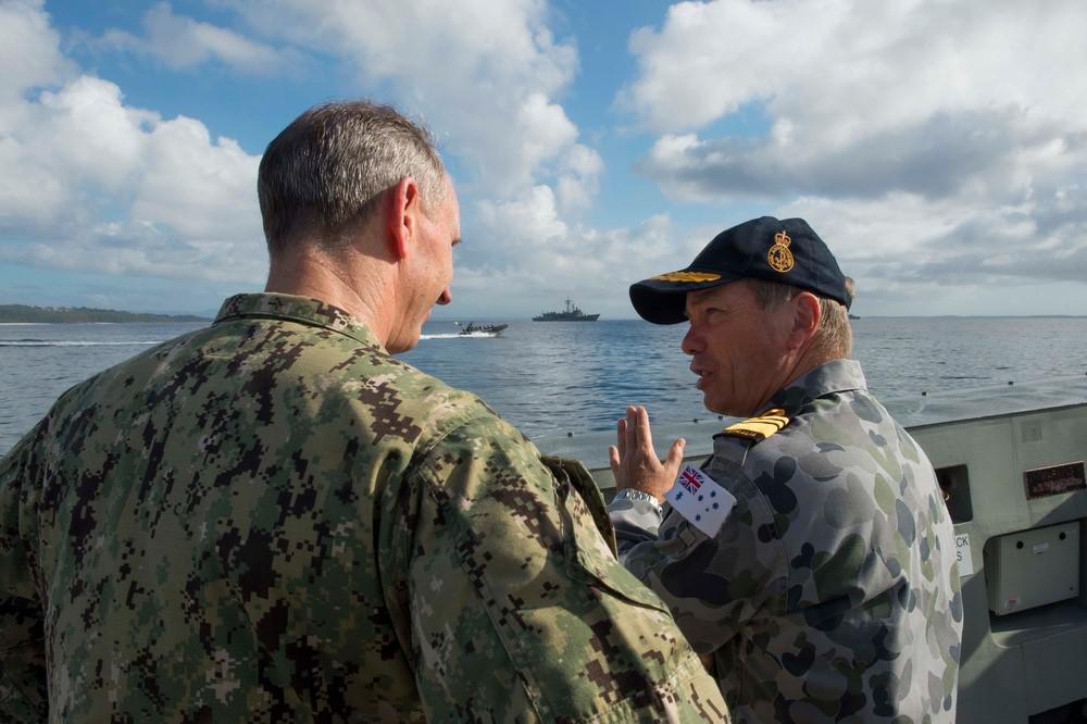 The Royal Australian Navy’s former Chief of Navy, Vice Adm. Tim Barrett, speaks with the U.S. Navy’s former Chief of Naval Operations, Adm. Jonathan Greenert, when they visited with officers and crew of the Canberra-class landing helicopter dock HMAS Canberra in February 2015. The two nations, along with Canada, New Zealand and the United Kingdom, are increasing their integration through enhanced information sharing.  U.S. Navy photo by Chief Mass Communication Specialist Peter D. Lawlor