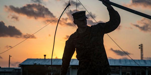 Cpl. Jacob Worshan, USMC, holds an antenna during a long distance, high frequency communications training event held on Camp Schwab, Okinawa, Japan. This training between 1st and 3rd Marine Division helps the units maintain a low electromagnetic signature that is virtually impervious to jamming and interference, which allows for distributed operations without detection in the operating environment.  Photo by Lance Cpl. Christian Ayers, USMC