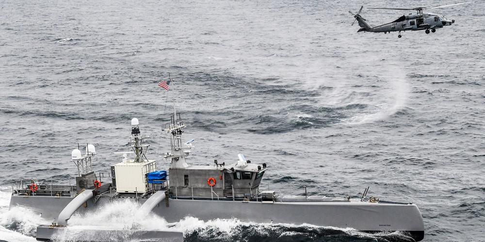 A Seahawk unmanned surface vessel in the Pacific Ocean and an MH-60R Sea Hawk helicopter from the Helicopter Maritime Strike Squadron 73 participate in U.S. Pacific Fleet’s Unmanned Systems Integrated Battle Problem 21 in April. Naval exercises have been crucial to aiding the integration of unmanned vessels into the fleet and pairing with manned capabilities, experts say. Credit: U.S. Navy/Chief Mass Communication Specialist Shannon Renfroe