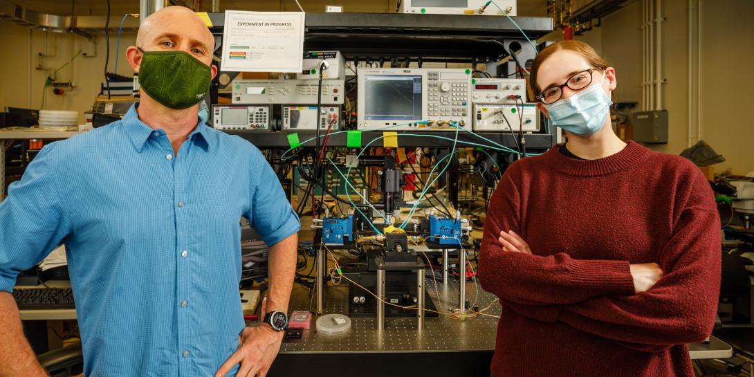 Matt Eichenfield (l) and Lisa Hackett, scientists at Sandia National Labs, recently created a groundbreaking acoustic circulator, a key radio component that separates transmitted and received signals, and is much smaller in size. Credit: Sandia National Labs/Bret Latter
