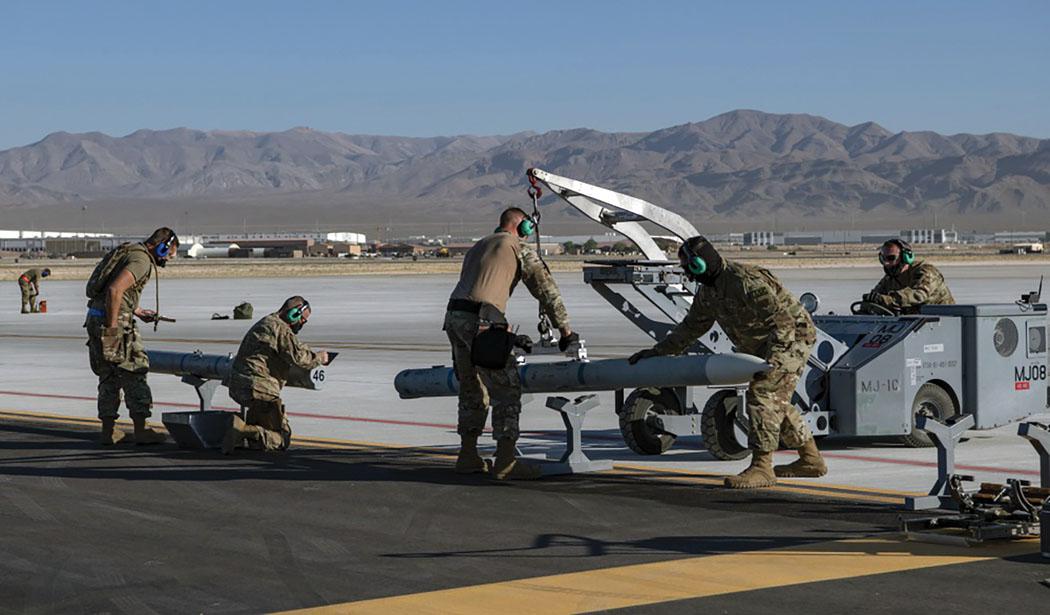 Airmen from the 140th Maintenance Group prepare to load munitions onto an F-16 Fighting Falcon from the 120th Fighter Squadron at a simulated austere base during the Advanced Battle Management System (ABMS) exercise on Nellis Air Force Base, Nevada, in September. The exercise at Nellis tested the digital integration of the U.S. Air Force’s ABMS with other weapons and communications systems in a Joint warfighting environment. Credit: Air Force photo by Tech. Sgt. Cory D. Payne