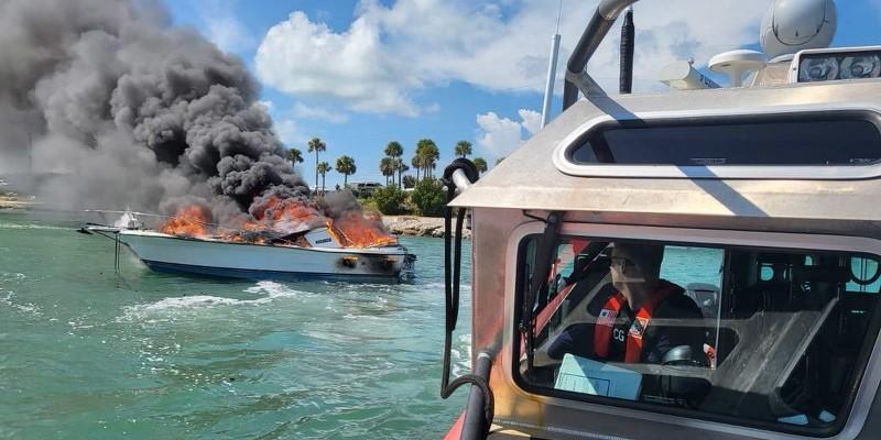 Responding to a vessel fire in the Whale Harbor Channel, near Islamorada in the Florida Keys on October 13, 2021, U.S. Coast Guard Petty Officer 3rd Class Logan Sayre manuevers with Petty Officer 3rd Class Broderick Jones (not pictured) to extinguish the flames after a Good Samaritan rescued the two passengers on board. To support its complex missions of sea rescue, homeland security and military-related operations, the service is expanding and modernizing its communications network.  U.S. Coast Guard photo