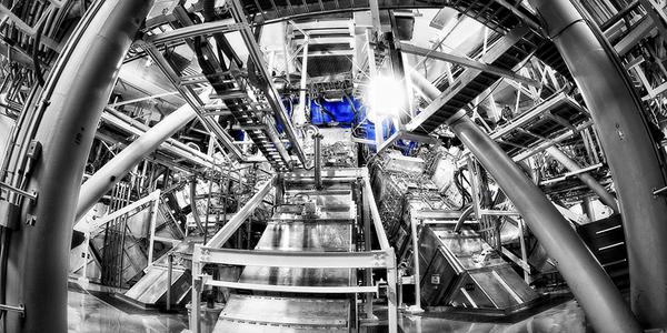 Beamlines entering the lower hemisphere of the National Ignition Facility’s target chamber. Lawrence Livermore researchers have successfully combined nine of the facility’s 192 laser beamlines into one directed pulse of light. (Photo: Damien Jemison/LLNL)
