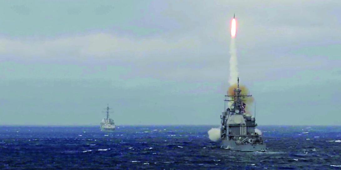 Ships assigned to the USS Dwight D. Eisenhower fire defensive missiles during a live-fire weapon system test. Carrier strike groups may need more integrated electronic warfare systems to defend against the antiship missile threat.
