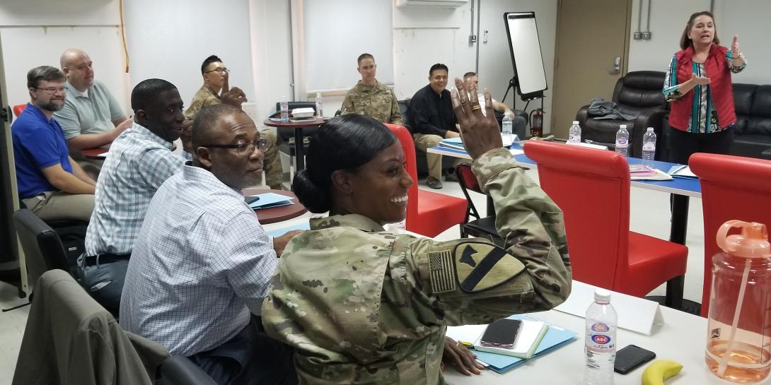 Maj. Nadine Quashie, USA, prepares to ask a question during a breakout session at a contracting symposium the 408th Contracting Support Brigade hosted at Camp Arifjan, Kuwait. Credit: U.S. Army photo by Staff Sgt. Robert Waters, USA