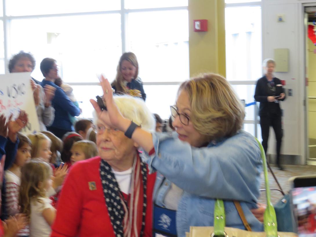 Vice Adm. Nancy Brown, USN (Ret.), and Pat Bixler (l), a nurse during World War II, take in the excitement generated from hundreds of greeters upon the arrival of the Honor Flight.