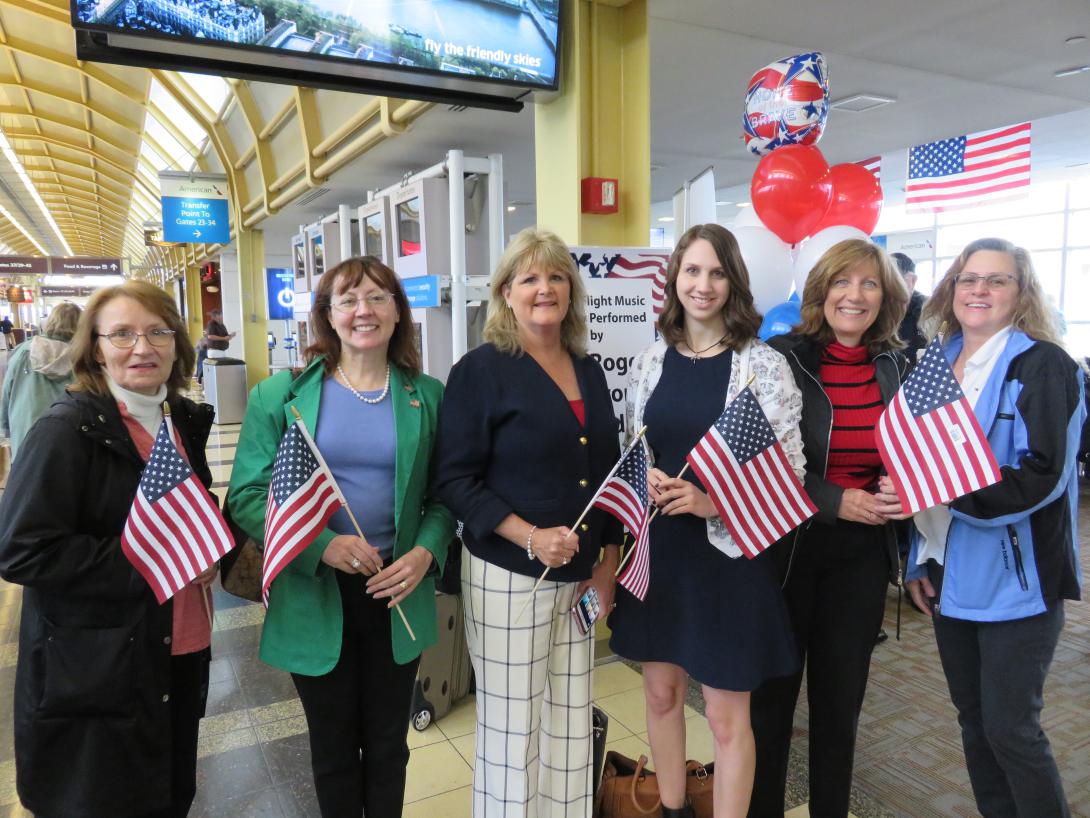 AFCEA staff members plus Washington DC Chapter member Dr. Danielle Zeedick prepare to meet and greet World War II and Korean War veterans arriving at Reagan National Airport from Marion, Illinois. 